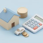 Small model house and car beside a calculator and stacked coins on a plain surface