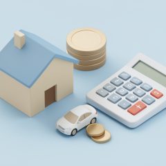 Small model house and car beside a calculator and stacked coins on a plain surface