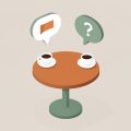 Isometric two speech bubbles over a small table with coffee cups, one bubble showing a flag and one a question mark, representing a boundary conversation in dating