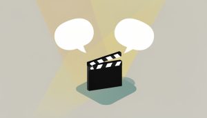 Isometric film clapperboard and two blank speech bubbles side by side on a stage, representing on-screen duos and behind-the-scenes reality
